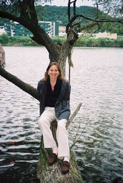 Anna Vtulochkina on a tree branch by the river