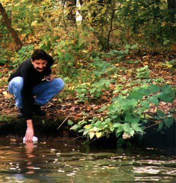 gary yakub taking a water sample