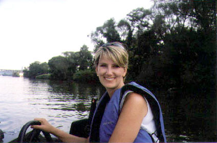 Kristen Kurland driving the boat on a river