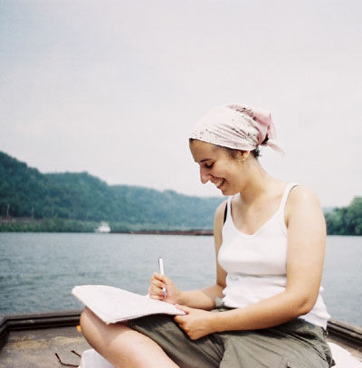 Lauren McEwen taking notes on the river